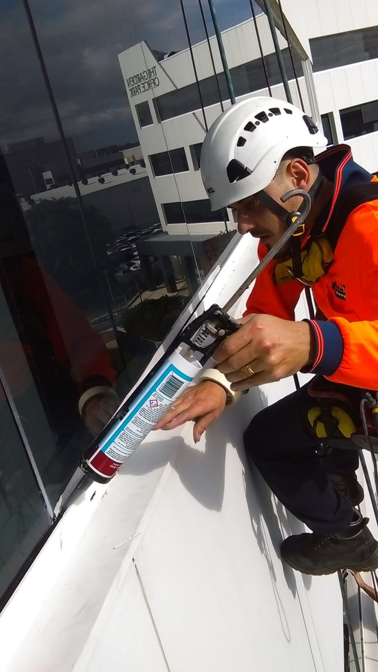 Alpha FM worker resealing façade repairs Perth